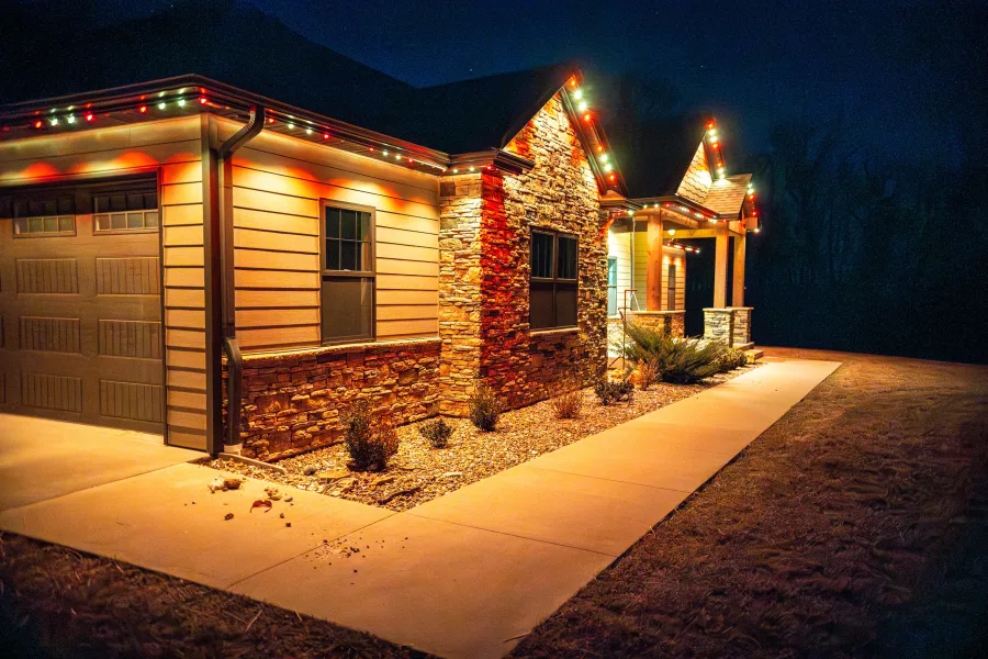 Warm orange Gemstone lighting on a stone home at night