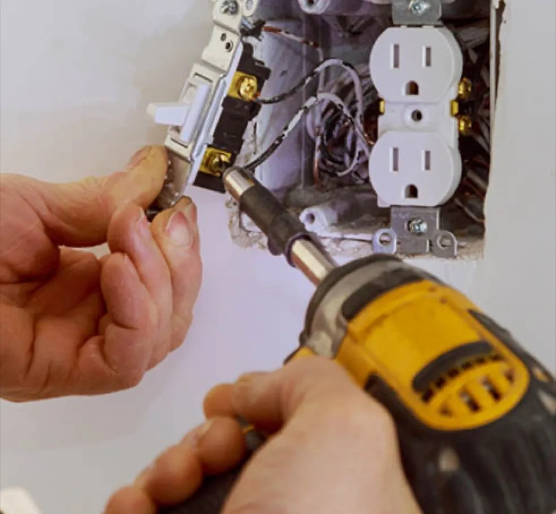 pe-hero-outlet Electrician testing an outlet in a Columbia home