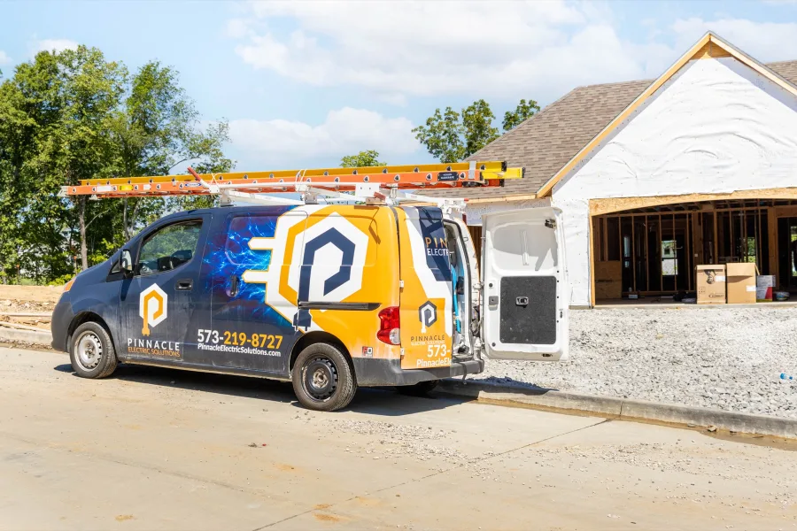 Pinnacle Electric Solutions van parked at a new home